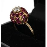 18ct domed ruby and diamond cluster ring, the diamond 0.50ct approx, clarity VS, colour J-K, in a