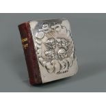 Miniature Edwardian silver front Book of Common Prayer embossed with angels amongst clouds,