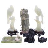 Pair of carved pale jade figures of birds perched upon branches, mounted upon shaped pierced and