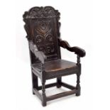 Charles II oak panel-back open armchair, south Yorkshire, circa 1670, with wavy foliate carved