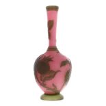 Small French overlaid cameo glass bottle vase, of slender form decorated with leaves on a pinkish