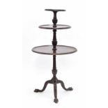 Georgian mahogany three tier circular dumb waiter, each moulded tier raised on reeded carved central