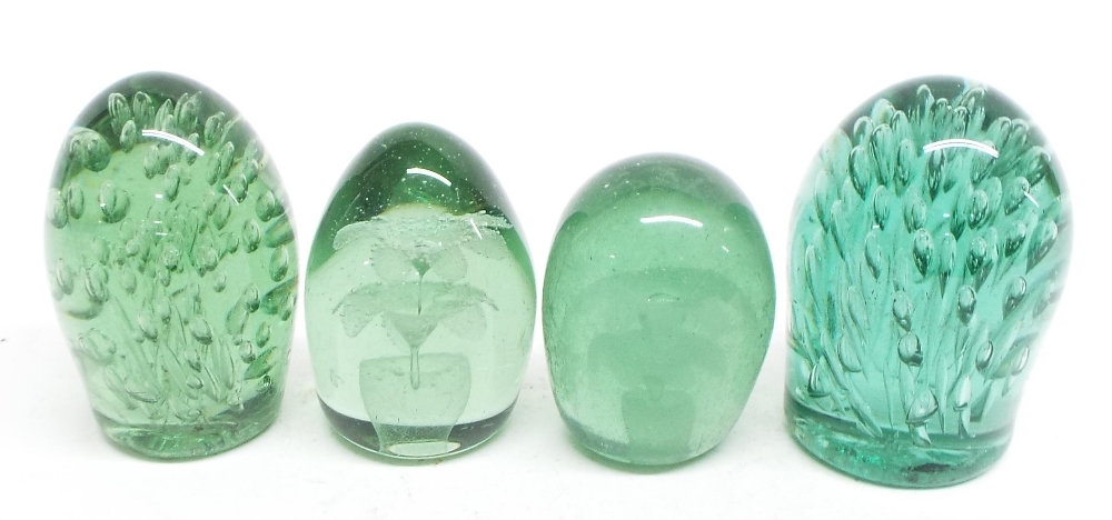 Four Nailsea type green glass dumps, the largest 5" high (4)