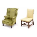 Georgian style wingback arm chair, green upholstery with tassel fringe, raised on square shaped