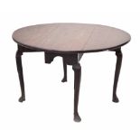 Irish George III mahogany drop leaf dining table, the plain top over arched end frieze, raised on