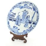 Chinese blue and white porcelain circular charger, decorated with three immortals within foliate