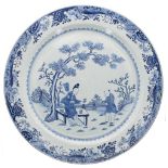 Extremely large 18th century Chinese blue and white porcelain charger, decorated with two figures in