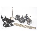 Three Arts & Crafts cast iron pierced shelf brackets, the two outer at 10" high to take 8" deep