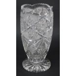 Good quality heavy cut glass vase, with starburst and geometric decoration around, on a circular