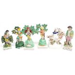 Four Staffordshire bocage figures, a single Staffordshire figure of a gardener and a Staffordshire