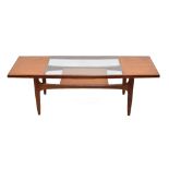 G Plan teak 'Long John' coffee table, with glazed inset panel and magazine shelf undertier, 54"