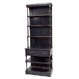 Aesthetic ebonised standing bookshelf, the carved pediment over panelled back and three shelves on