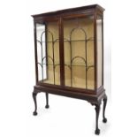 1920s mahogany display cabinet, the moulded top over a blind fret carved frieze and astragal