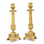 Pair of decorative ormolu candlesticks, each with reeded columns and cast scroll supports upon