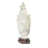 Chinese carved hardstone vase and cover, of tapered form surmounted with a mystical dog over ring