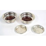 Pair of P H Vogel & Co. silver wine coasters, with turned hardwood bases on green baize,