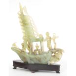 Good Chinese carved jade model of a sailing boat with two figures, upon a hardwood base, 14" high;
