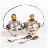 Polish Art Nouveau cruet set on stand, the covers with stylized amber rose flower heads, the two