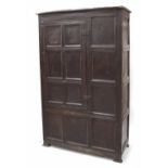 Charles II oak press or livery cupboard, the twelve panelled front with single iron hinged door,