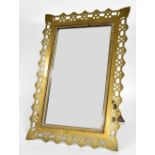 Aesthetic brass plated easel mirror, the rectangular plate within a stylised pierced surround, 16" x