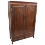 Chinese hardwood cupboard, with two panelled doors enclosing shelved interior, over two short