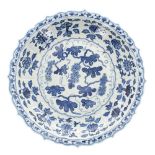 Chinese blue and white porcelain circular shallow charger, painted with grapes within a moulded