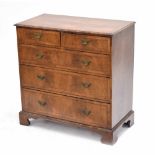 Georgian walnut veneered chest of drawers, the cross banded moulded top over two short and three