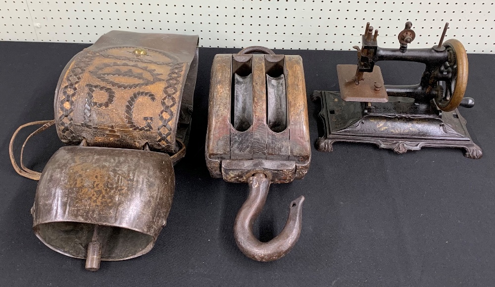 Victorian table-top manual wind sewing machine, 11" wide; together with a ship's winch pulley, 16"