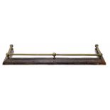 Late Victorian iron and brass fire fender, brass rail over frieze of repeated geometric motif,