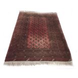 Turkoman style patterned red ground carpet, 63" x 96"