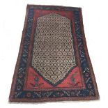 Persian patterned red ground rug, decorated with foliate central shield within foliate and floral