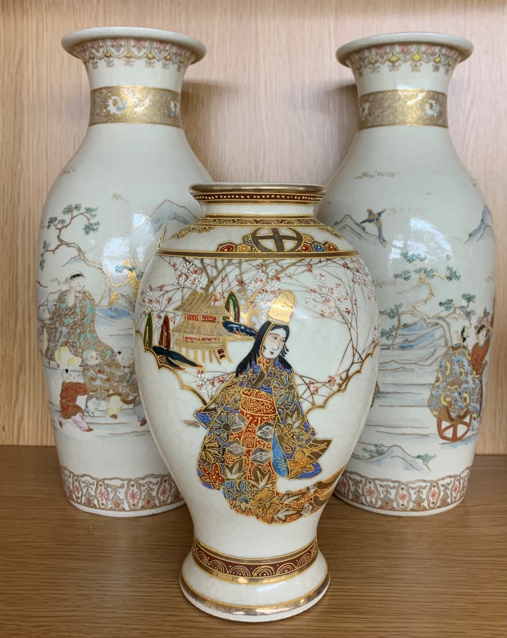 Pair of Japanese Satsuma vases decorated with figures in landscapes, impressed seal mark, 13.5" high