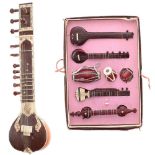 Miniature Indian sitar; together with a boxed set of miniature Indian musical instruments (2)