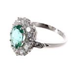 Good platinum emerald and diamond oval cluster ring, the emerald estimated 2.00ct, with a surround