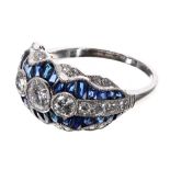 Fine quality platinum sapphire and diamond dress ring, with three principle round diamonds in a