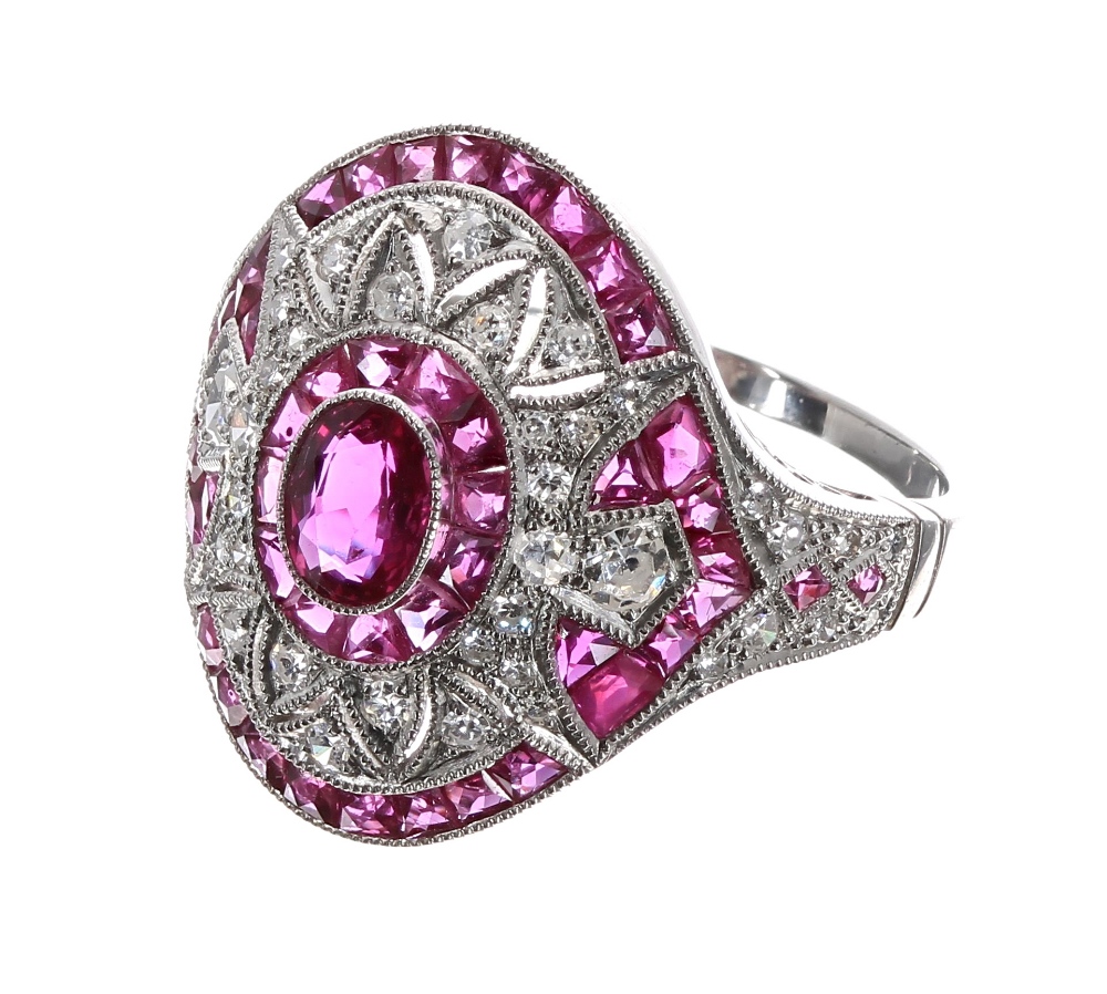 Ornate platinum ruby and diamond oval cocktail ring, set with oval ruby surrounded by a halo of