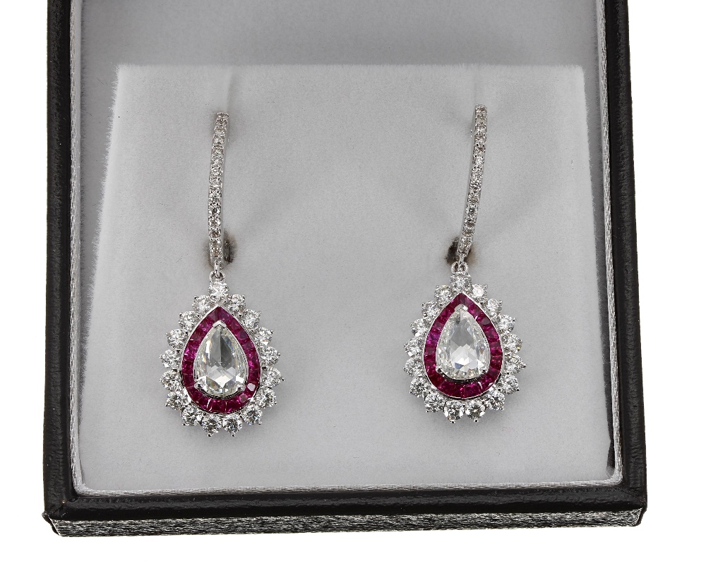 Superb pair of white gold ruby and diamond drop earrings, each with central pear shaped old-cut