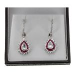 Superb pair of white gold ruby and diamond drop earrings, each with central pear shaped old-cut