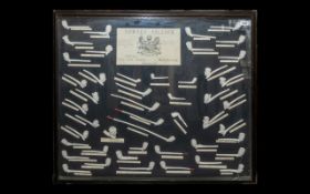 A Large Glazed Wall Display containing approx 47 clay pipes. All numbered and described with central