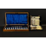 A Box of Twelve Mother of Pearl Handled Fish Knives and Forks, silver ferrules and plated blades.