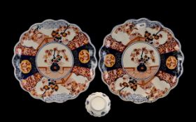 Japanese Imari Chargers - a pair with shaped edges of typical form and palette. 14'' diameter.