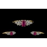 18ct Gold - Attractive Ruby and Diamond Dress Ring. The Central Ruby of Excellent Rich Red Colour.