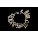 A Vintage Sterling Silver Charm Bracelet loaded with 20 silver charms.