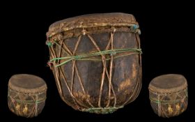 Tribal Antique Wood Drum hewn form a tree trunk with a skin applied. Decorated in string cords.