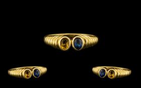 18ct Gold Attractive 2 Stone Yellow and Blue Sapphire Set Dress Ring - attractive rub over setting.