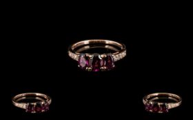 Rose Garnet and Diamond Ring, three oval cut rose garnets,