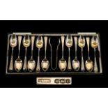 A Boxed Set of 12 Silver Teaspoons with Sugar Tongs from the 1930's - hallmark Sheffield 1936.