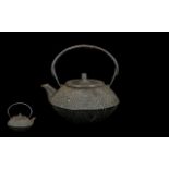An Antique Japanese Cast Iron Tea Kettle with a moulded dotted body Meiji period character marks to
