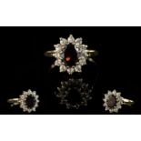 A Vintage 9ct Gold Attractive Garnet And CZ Set Cluster Ring. Flower head design.