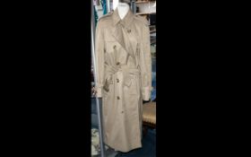 A Burberry Trench Coat in traditional camel colour with Burberry checked lining.